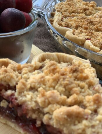 Cherry Crumble Pie with bowl of cherries