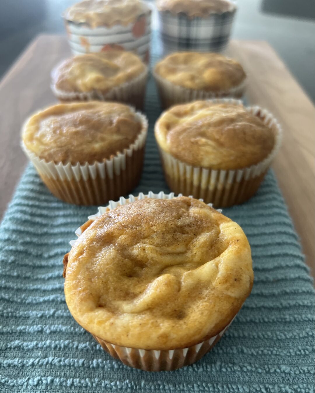 Pumpkin Cream Cheese Muffins on Teal Decorative Towel